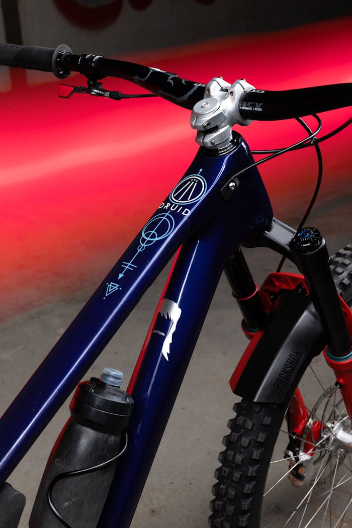 Detailed photo of a mountain bike frame with a vibrant red background for creative design use.