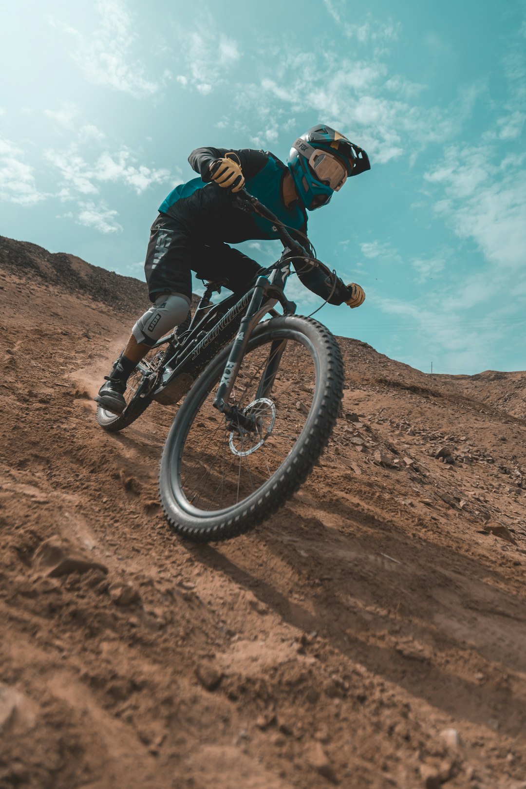 man-in-black-jacket-riding-on-black-mountain-bike-on-brown-field-during-daytime-octeop9idp4