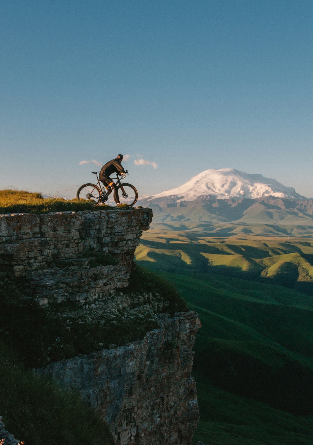 man-riding-bike-on-cliff-at-daytime-9qsk2qhidmg